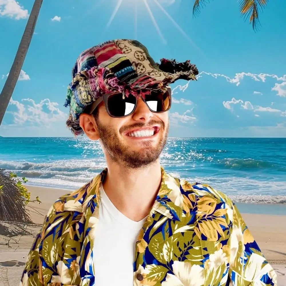 Man in a floral shirt and sunglasses on a beach with palm trees
